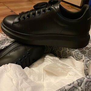 Alexander McQueen Men Sneakers, the sneakers is all black and a size 10.5